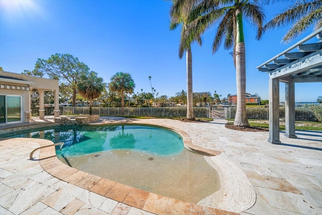 view of pool with a pool with connected hot tub, fence, and a patio