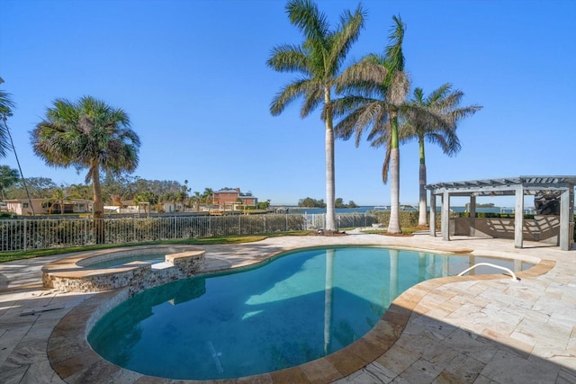 view of swimming pool featuring a patio area, a pool with connected hot tub, fence, and a pergola