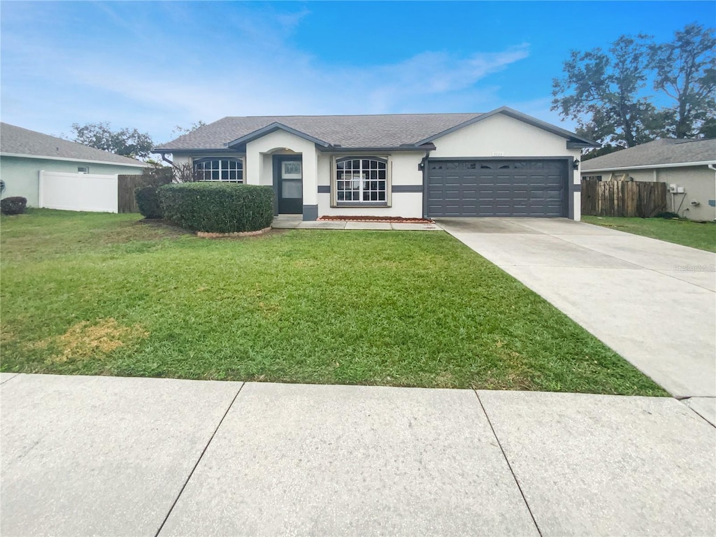 7224 Highland Loop, Zephyrhills, FL 33541 - single story home with a garage and a front lawn