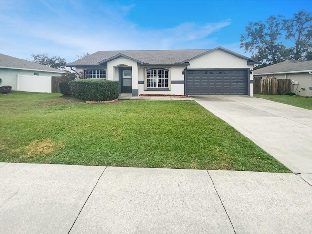 single story home with a garage and a front lawn