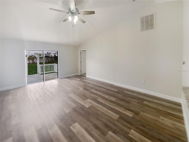 spare room featuring vaulted ceiling, dark hardwood / wood-style floors, and ceiling fan