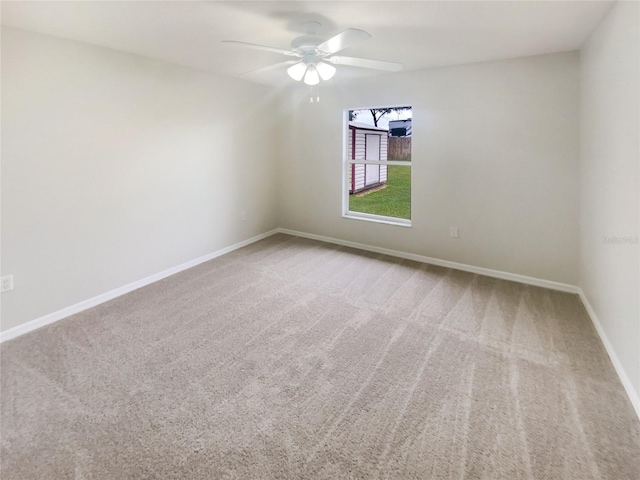 spare room with carpet floors and ceiling fan