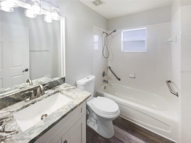 full bathroom with shower / bathing tub combination, vanity, hardwood / wood-style flooring, and toilet