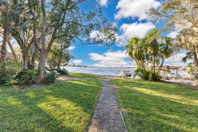 exterior space with a water view and a lawn