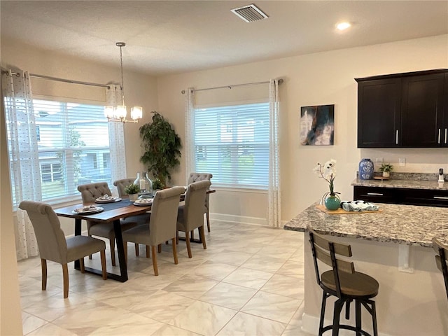 dining space with a chandelier