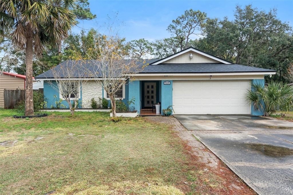 single story home with a garage and a front yard