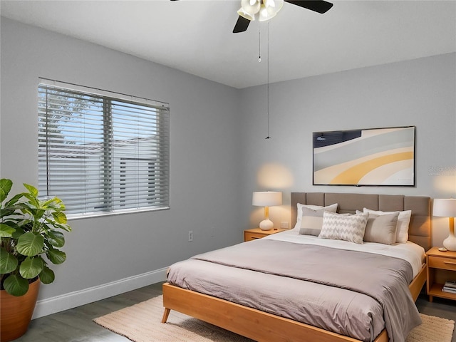 bedroom featuring ceiling fan and dark hardwood / wood-style floors