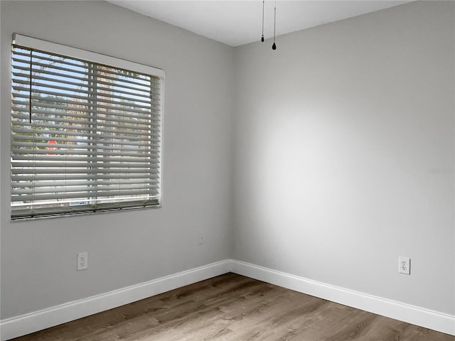 spare room with wood-type flooring