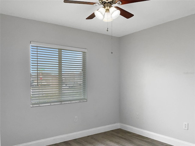 empty room with dark wood-type flooring and ceiling fan