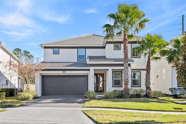 view of front facade with a front yard and a garage