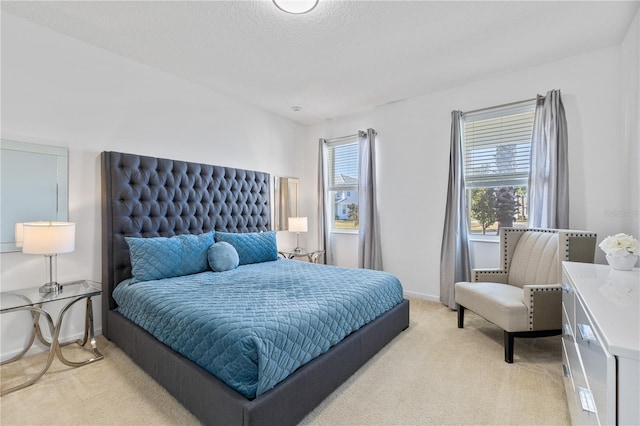 bedroom with light colored carpet and multiple windows