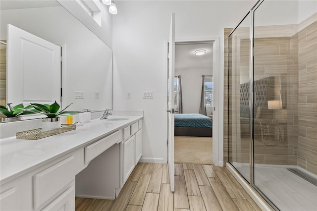 bathroom featuring vanity and a shower with shower door