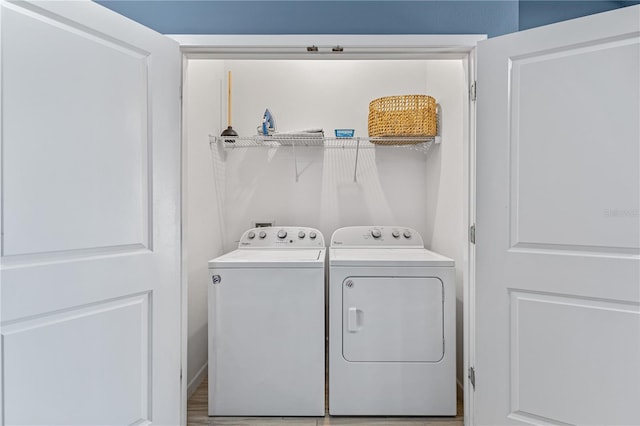 clothes washing area with washing machine and dryer