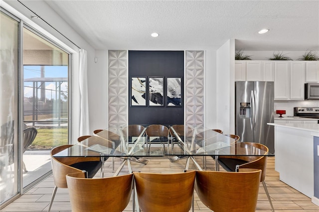 dining space with a textured ceiling