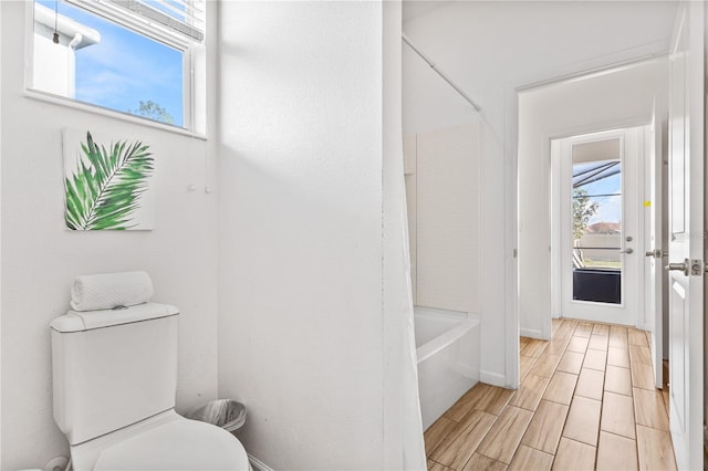 bathroom with toilet and shower / tub combination