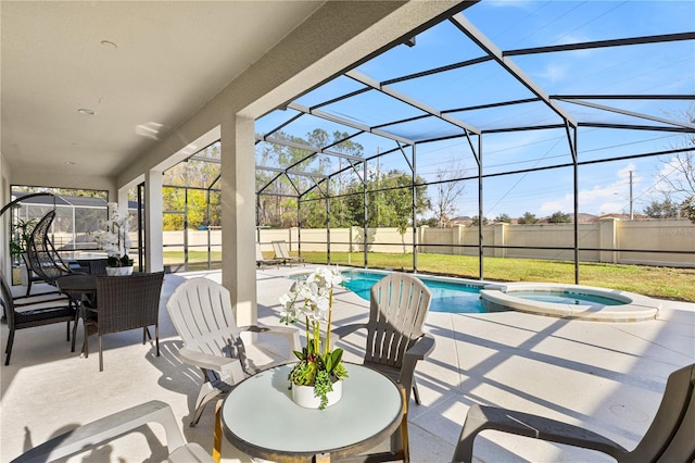 view of patio / terrace featuring a pool with hot tub and a lanai