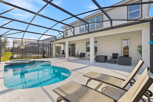 view of swimming pool with an in ground hot tub, a lanai, and a patio