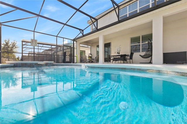 view of pool with glass enclosure, a patio area, and a jacuzzi