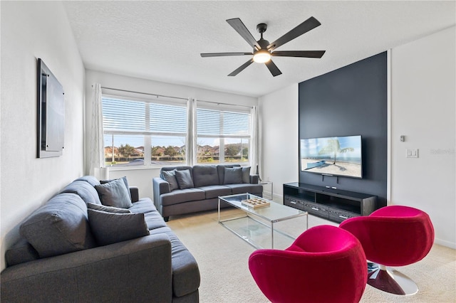 living room featuring carpet flooring, a textured ceiling, and ceiling fan