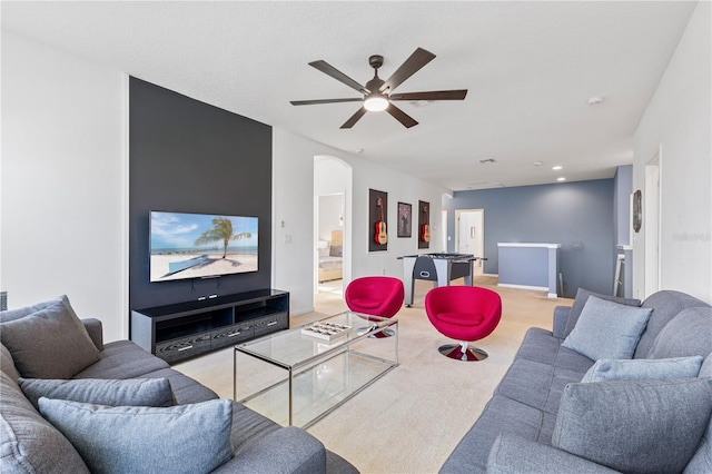 living room with ceiling fan and light colored carpet