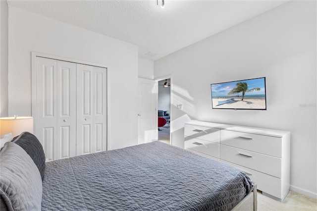 bedroom with light carpet and a closet