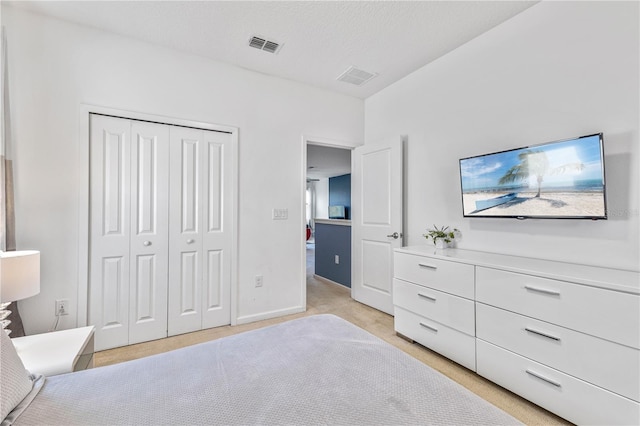 bedroom with a closet and light colored carpet