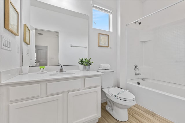 full bathroom with toilet, vanity, and shower / washtub combination