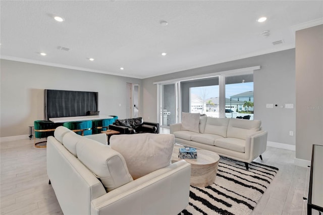 living room featuring crown molding and light hardwood / wood-style floors