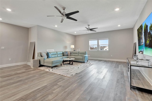 living room featuring a textured ceiling and light hardwood / wood-style floors