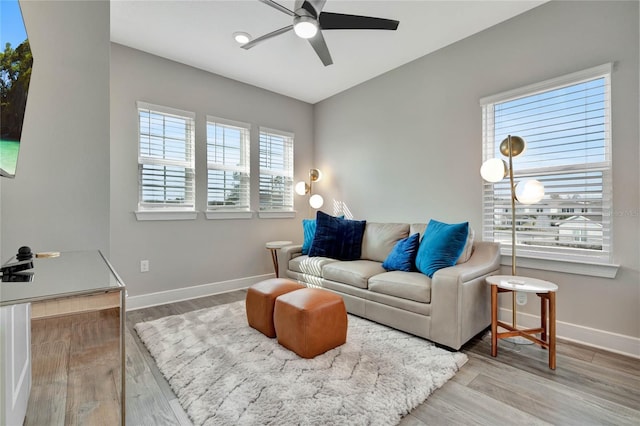 living room with wood-type flooring, a healthy amount of sunlight, and ceiling fan