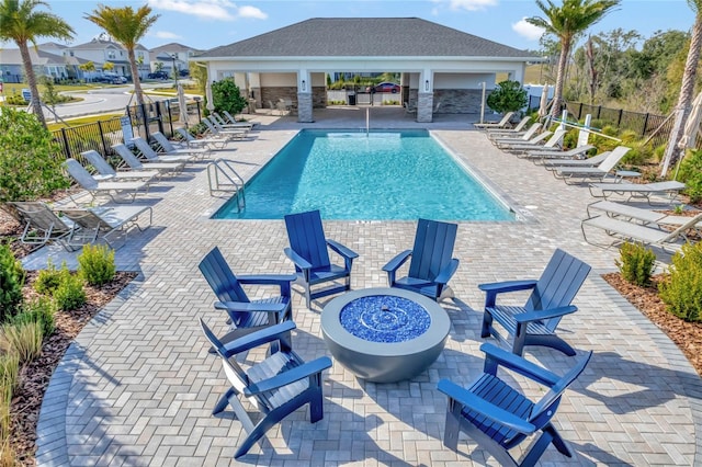 view of pool featuring a patio area and an outdoor fire pit