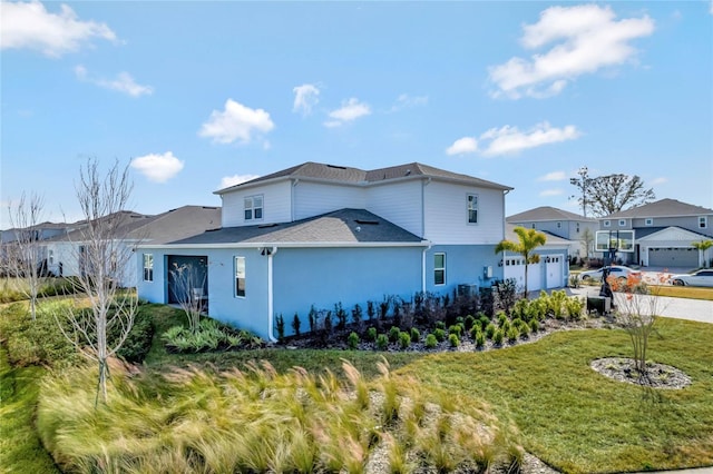 view of home's exterior featuring a garage and a lawn