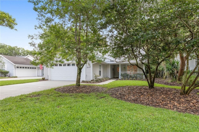 view of front of home with a front yard and a garage