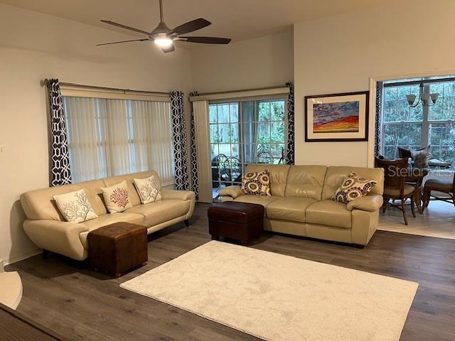 living room with ceiling fan and dark hardwood / wood-style floors