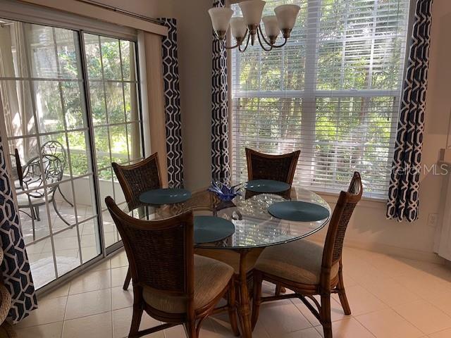 tiled dining area featuring a chandelier and a wealth of natural light