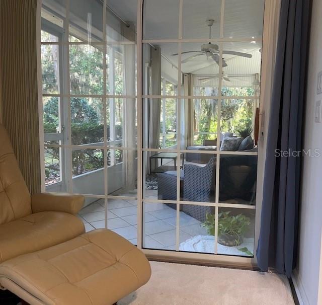 sunroom / solarium featuring ceiling fan and a wealth of natural light