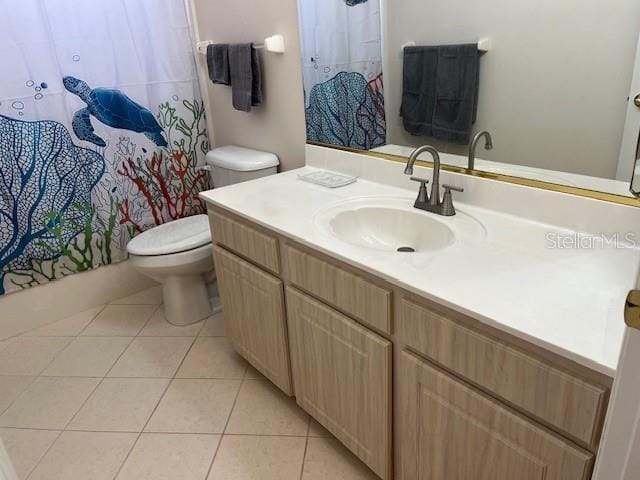 bathroom with vanity, toilet, walk in shower, and tile patterned flooring