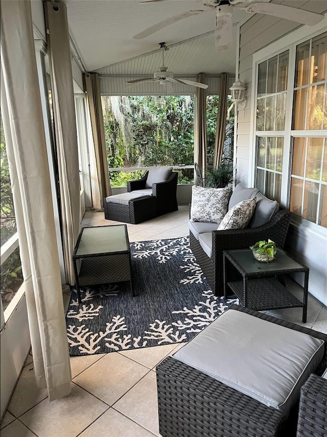 sunroom / solarium featuring ceiling fan and vaulted ceiling