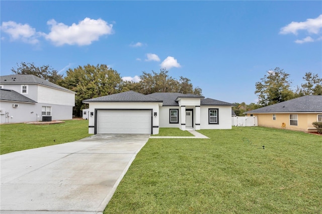 view of front facade with central AC unit, a garage, and a front yard