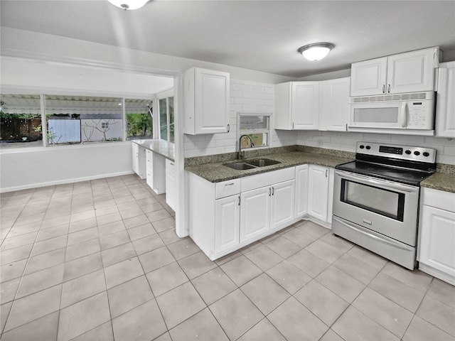 kitchen featuring white cabinetry, sink, light tile patterned floors, and electric stove