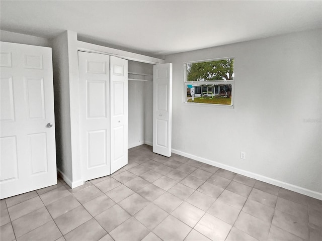 unfurnished bedroom with a closet and light tile patterned floors