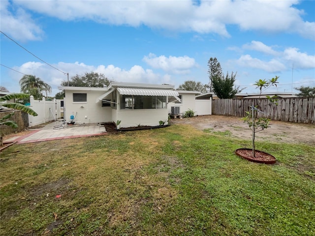 rear view of house featuring a patio area and a lawn