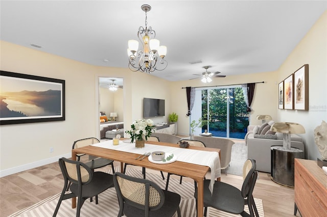 dining space featuring ceiling fan with notable chandelier and light hardwood / wood-style floors