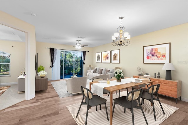 dining area featuring light wood-type flooring and an inviting chandelier