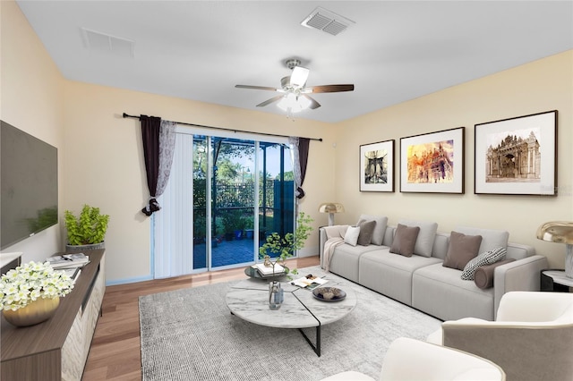 living room with ceiling fan and light hardwood / wood-style floors