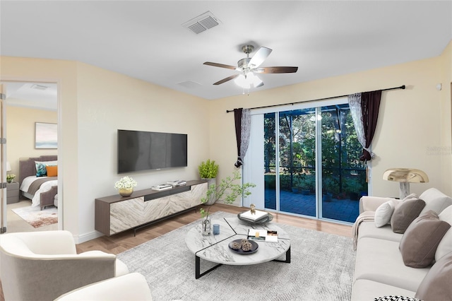 living room with ceiling fan and wood-type flooring