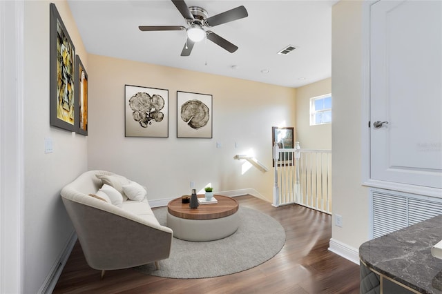 sitting room with hardwood / wood-style flooring and ceiling fan