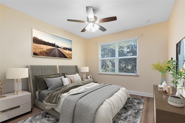 bedroom with ceiling fan and dark hardwood / wood-style floors