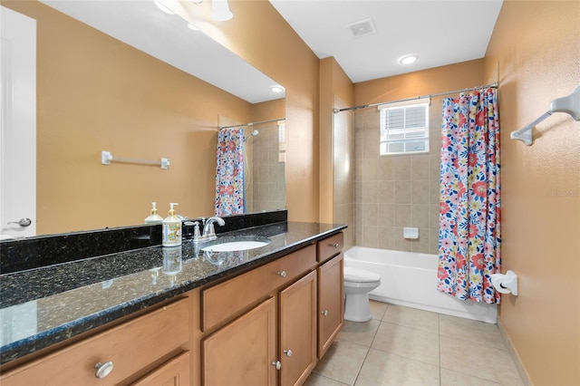 full bathroom featuring toilet, tile patterned flooring, vanity, and shower / tub combo with curtain