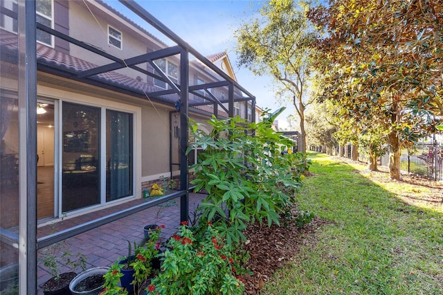 view of yard featuring glass enclosure